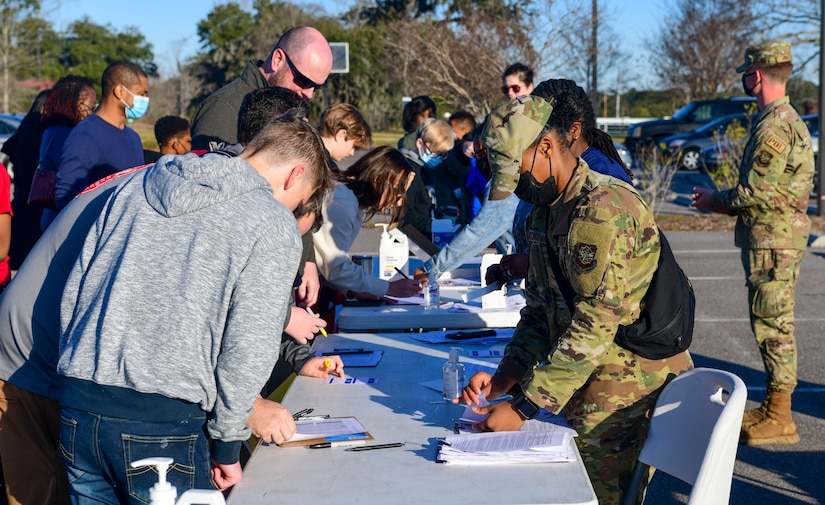 Participants of the Accelerating the Legacy Showcase sign-up to register for a tour at Palmetto Scholars Academy, North Charleston, South Carolina, Feb. 19, 2022. The ATL showcase honors the legacy of the heroic Tuskegee Airmen in a two-day event highlighting professional development and community outreach.