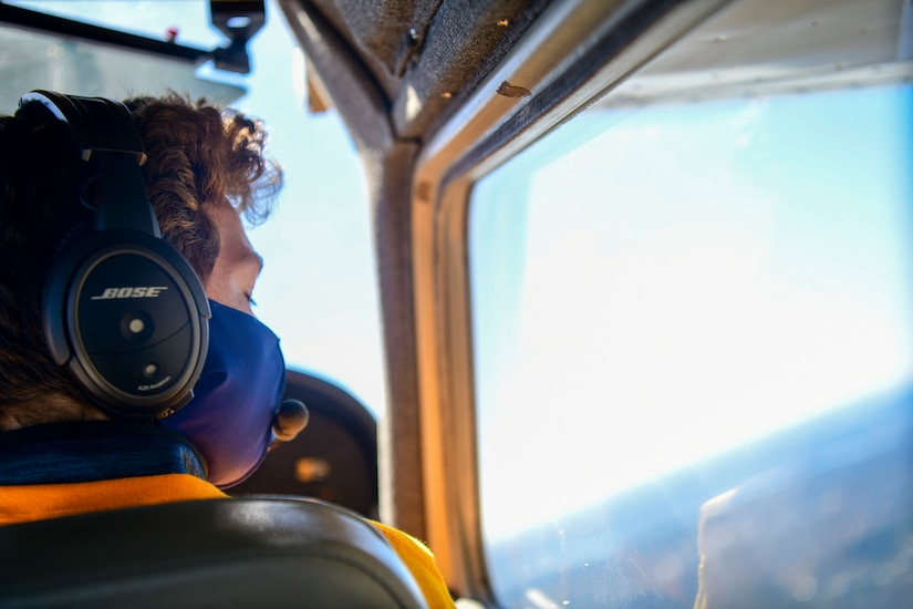 A participant of the Accelerating the Legacy Showcase gazes out of the window of a Cessna single-engine aircraft while flying above Joint Base Charleston, South Carolina, Feb. 19, 2022. The Accelerating the Legacy Showcase honors the legacy of the heroic Tuskegee Airmen in a two-day event highlighting professional development and community outreach.