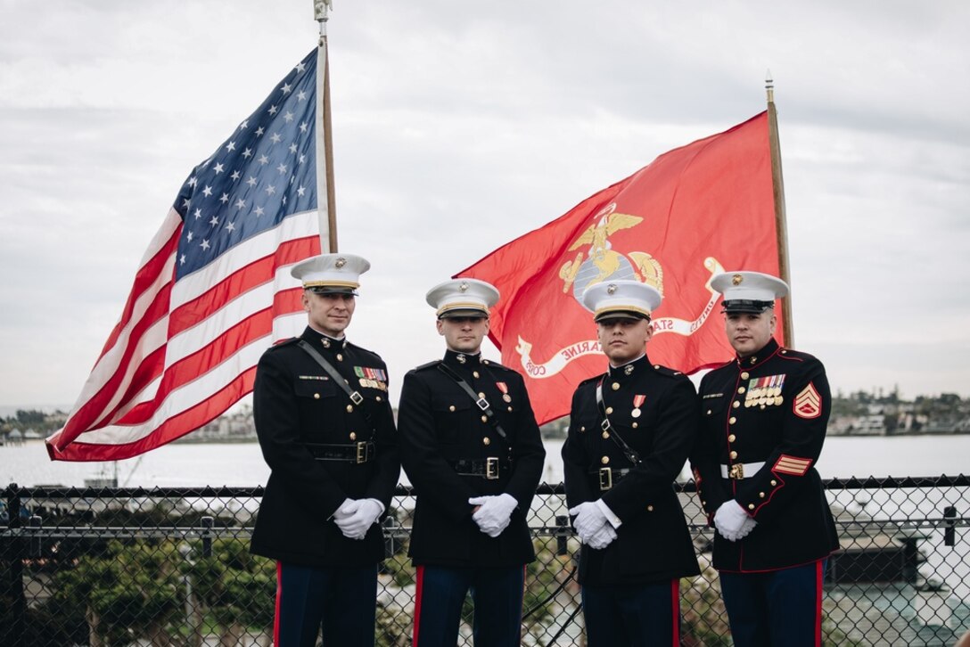 U.S. Marines pose on the flight deck of the USS Midway after the commissioning ceremony for 2nd Lt. Trevor Salom and 2nd Lt. Stephen Lofy in San Diego, California on Jan. 29, 2022. A commissioning ceremony is the culminating event of an officer’s career, signifying the transformation from candidate to officer. (U.S. Marine Corps photo by Sgt. Alina Thackray)