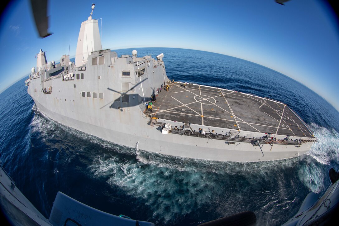 A military ship sails on the ocean.