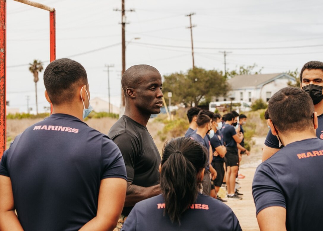 U.S. Marine Corps Major Gordon Emmanuel, the commanding officer for Recruiting Station Orange County, speaks with future Marines about how to train and better prepare themselves to further progress their pull-up ability during a training event at Seal Beach, California on May 15, 2021. RS Orange County hosted a training function for future Marines who are expected to ship this summer for recruit training at Marine Corps Recruit Depot San Diego. (U.S. Marine Corps photo by Sgt. Sarah Ralph)