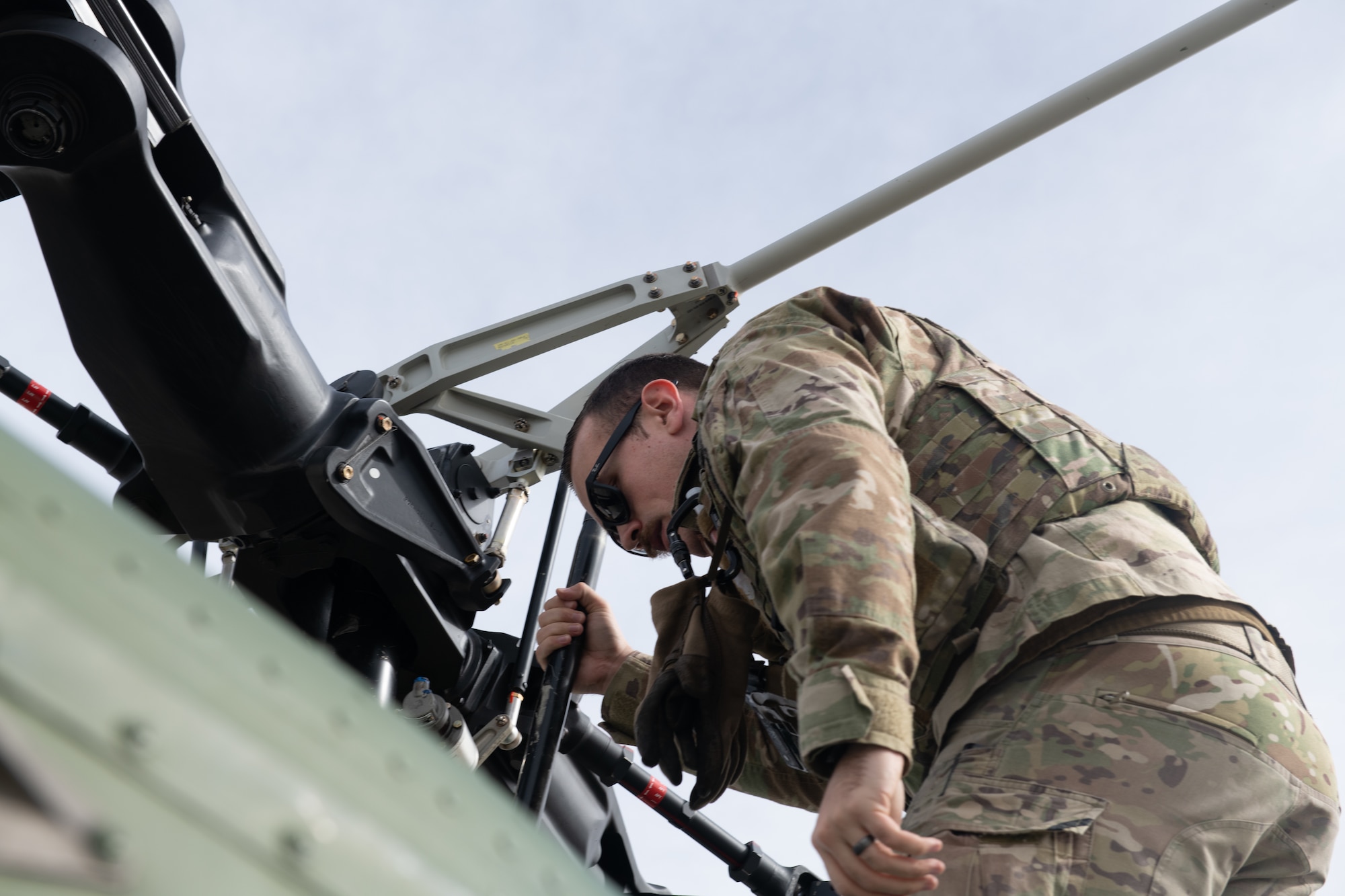 Tech. Sgt. John Griggs, 37th Helicopter Squadron flight engineer, completes a pre-flight check on his helicopter, February 15, 2022 on F.E. Warren Air Force Base, Wyoming. The purpose of a pre-flight check is to make sure the UH-1N Huey is in correct working order prior to take off. (U.S. Air Force photo by Airman Sarah Post)