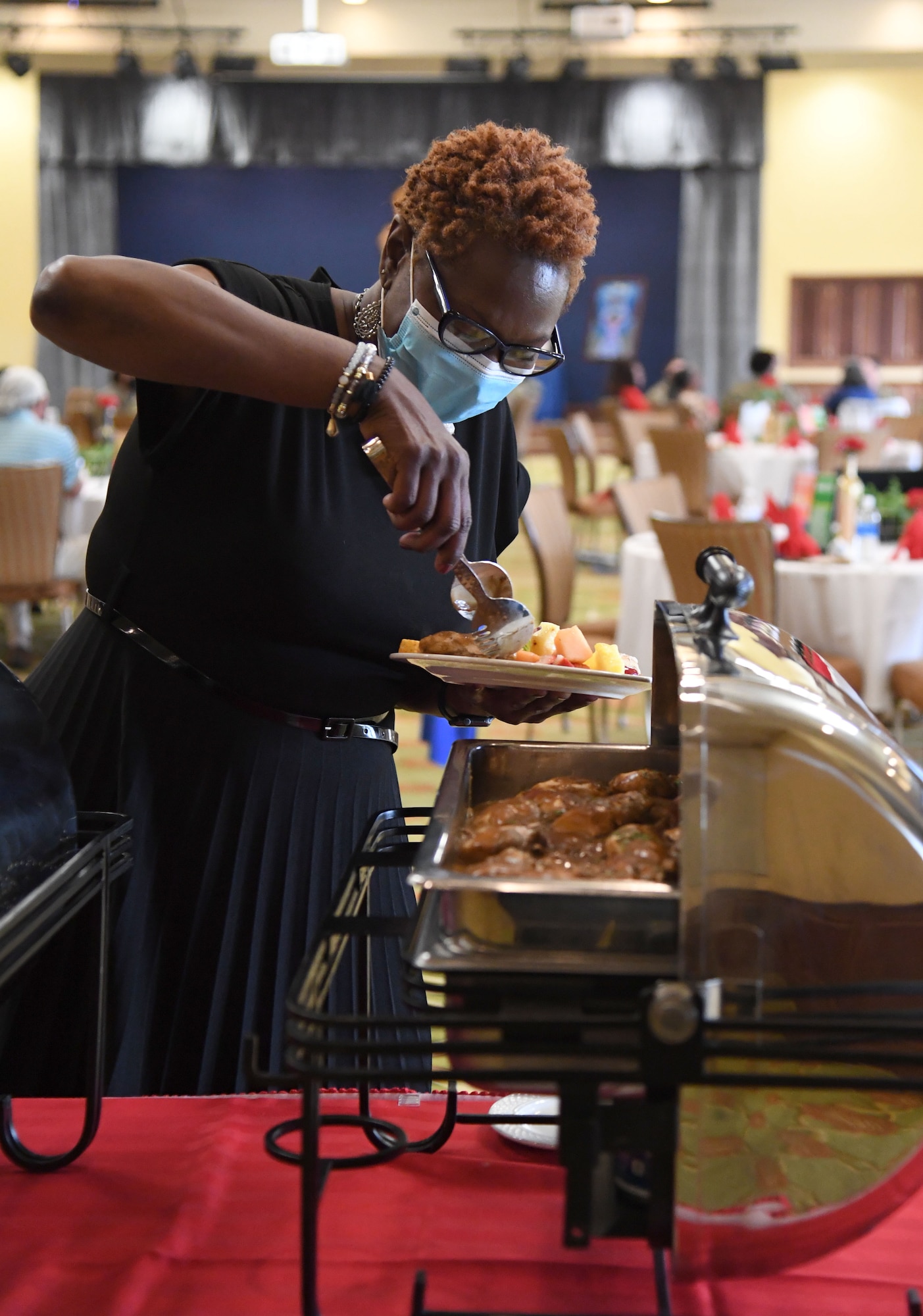 Ruby Bordley, 81st Force Support Squadron Air Force aid officer, prepares a plate of food during the Black History Month Gospel Brunch inside the Bay Breeze Event Center at Keesler Air Force Base, Mississippi, Feb. 22, 2022. This year's theme for Black History Month, which is celebrated throughout February, is black health and wellness. (U.S. Air Force photo by Kemberly Groue)