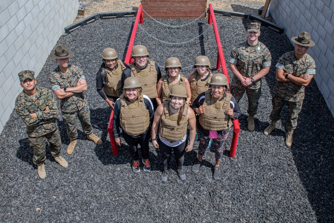 Educators from the Riverside, California region, pose for a group photo during the 12th Marine Corps District Educator's Workshop at Marine Corps Base Camp Pendleton, California, June 23, 2021. The Educator's Workshop is a four-day program designed to better inform high school and college teachers, coaches, counselors and influencers about the benefits and opportunities available during service in the Marine Corps. This allows attendees to return home and provide firsthand experience and knowledge to individuals interested in military service. (U.S. Marine Corps photo by Cpl. Ana S. Madrigal)