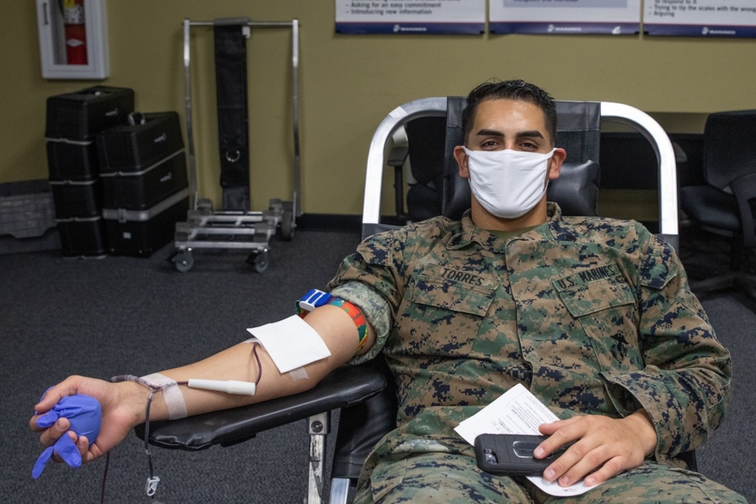 U.S. Marine Corps Sgt. Ricardo Torres the supply clerk for Recruiting Station Riverside, 12th Marine Corps District, poses for a picture during a blood drive on March Air Reserve Base, California, January 15, 2021. This year, local blood banks have seen a major decrease in donations due to the COVID-19 pandemic, making blood donations extremely important for our communities. ( U.S. Marine Corps photo by Cpl. Ana S. Madrigal)