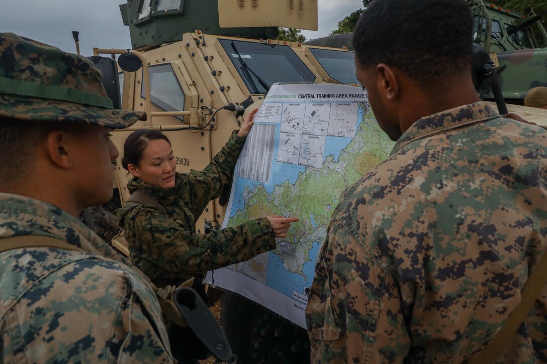 U.S. Marine Corps 1st Lt. Kristen Dang, a platoon commander with Combat Logistics Company Alpha, Combat Logistics Battalion 3, Combat Logistics Regiment 3, discusses the plan of the day during Jungle Warfare Exercise 22, Feb. 16, 2022, Landing Zone Dodo, Okinawa, Japan. JWX is a large-scale field training exercise focused on leveraging the integrated capabilities of joint and allied partners to strengthen all-domain awareness, maneuver, and fires across a distributed maritime environment. CLC-A is forward-deployed in the Indo-Pacific under Combat Logistics Battalion 4. (U.S. Marine Corps photo by Lance Cpl. Federico Marquez)