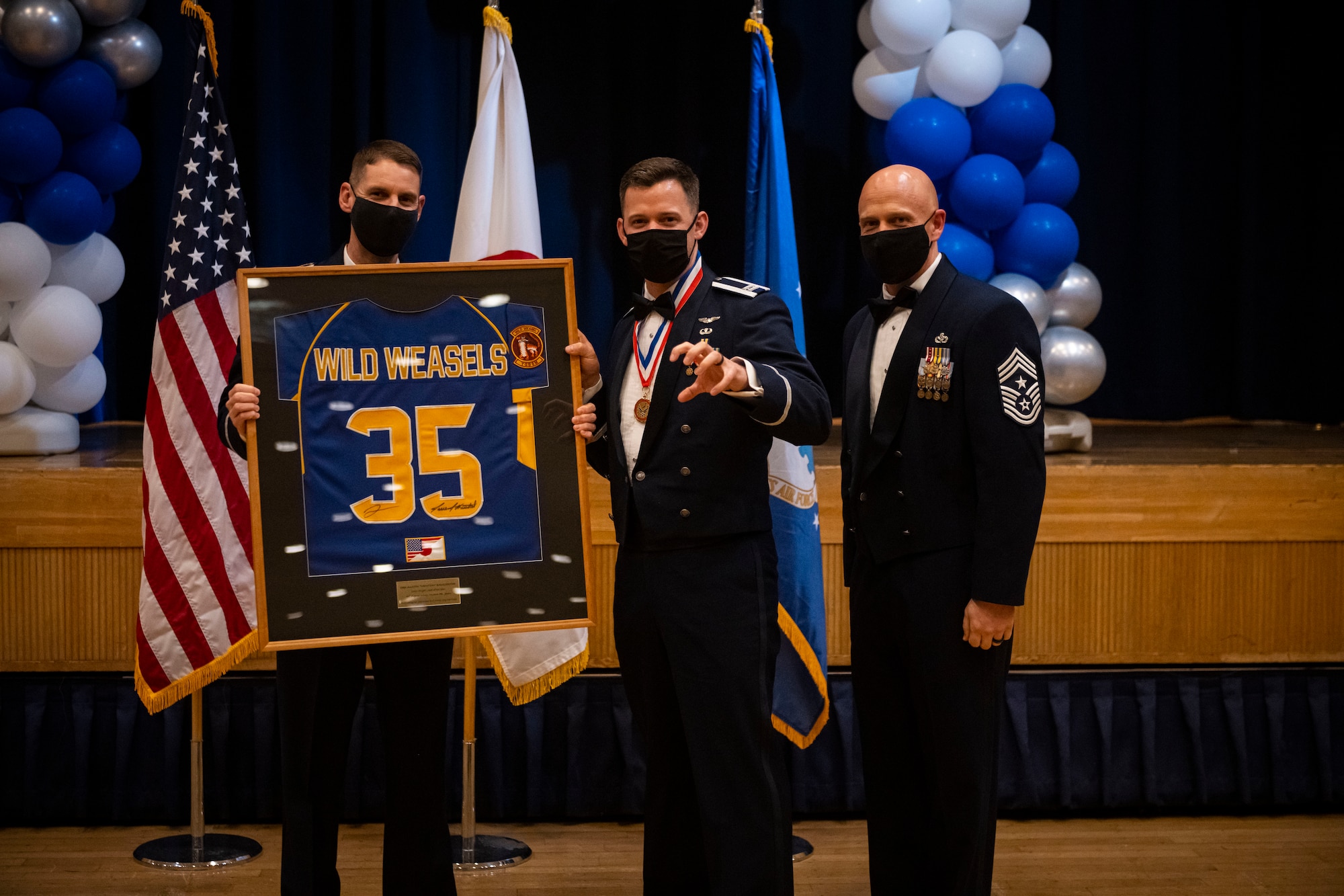 A military member poses with leadership after winning the annual award.