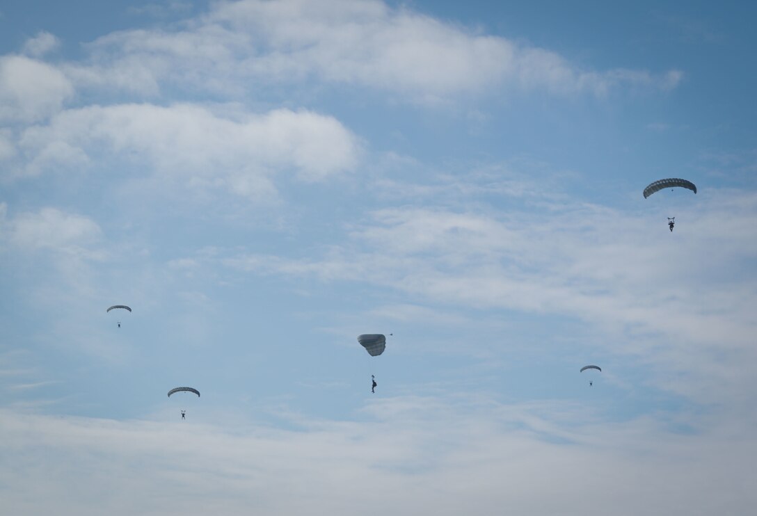 U.S. Marines with 3d Landing Support Battalion, Combat Logistics Regiment 3, descends to the drop zone jumping in support of establishing a forward refueling point, Ie Shima, Okinawa, Japan, Jan. 27, 2022. 3rd LSB conducted a battalion field exercise to train core mission essential tasks and rehearse emerging warfighting concepts in preparation for future exercises and operations. 3d MLG, based out of Okinawa, Japan, is a forward-deployed combat unit that serves as III MEF’s comprehensive logistics and combat service support backbone for operations throughout the Indo-Pacific area of responsibility. (U.S. Marine Corps photo by Lance Cpl. Madison Santamaria)