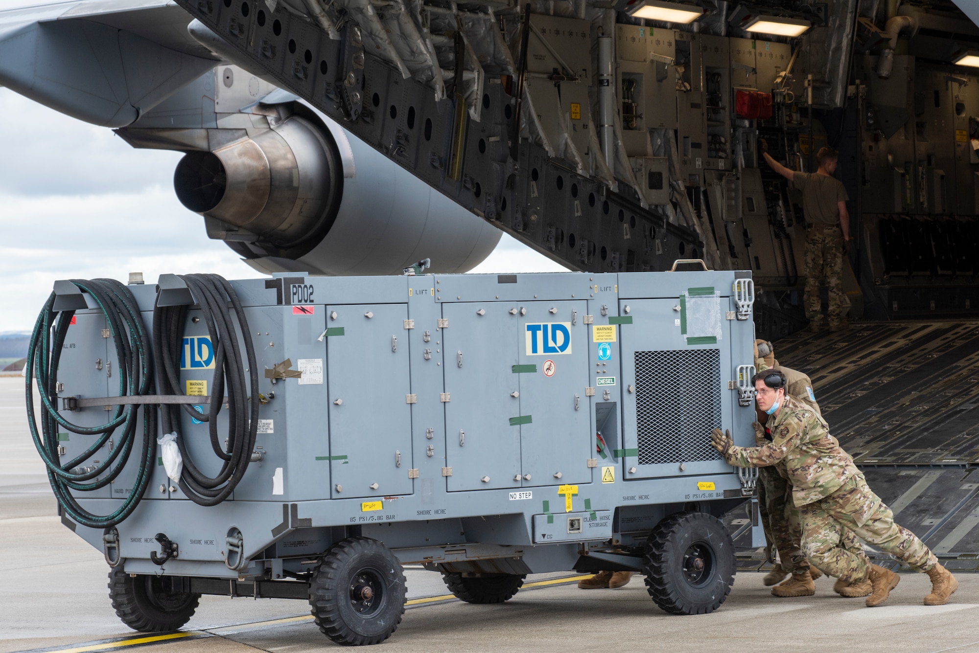 Airmen from the 726th Air Mobility squadron unload cargo from a C-17 Globemaster III aircraft.