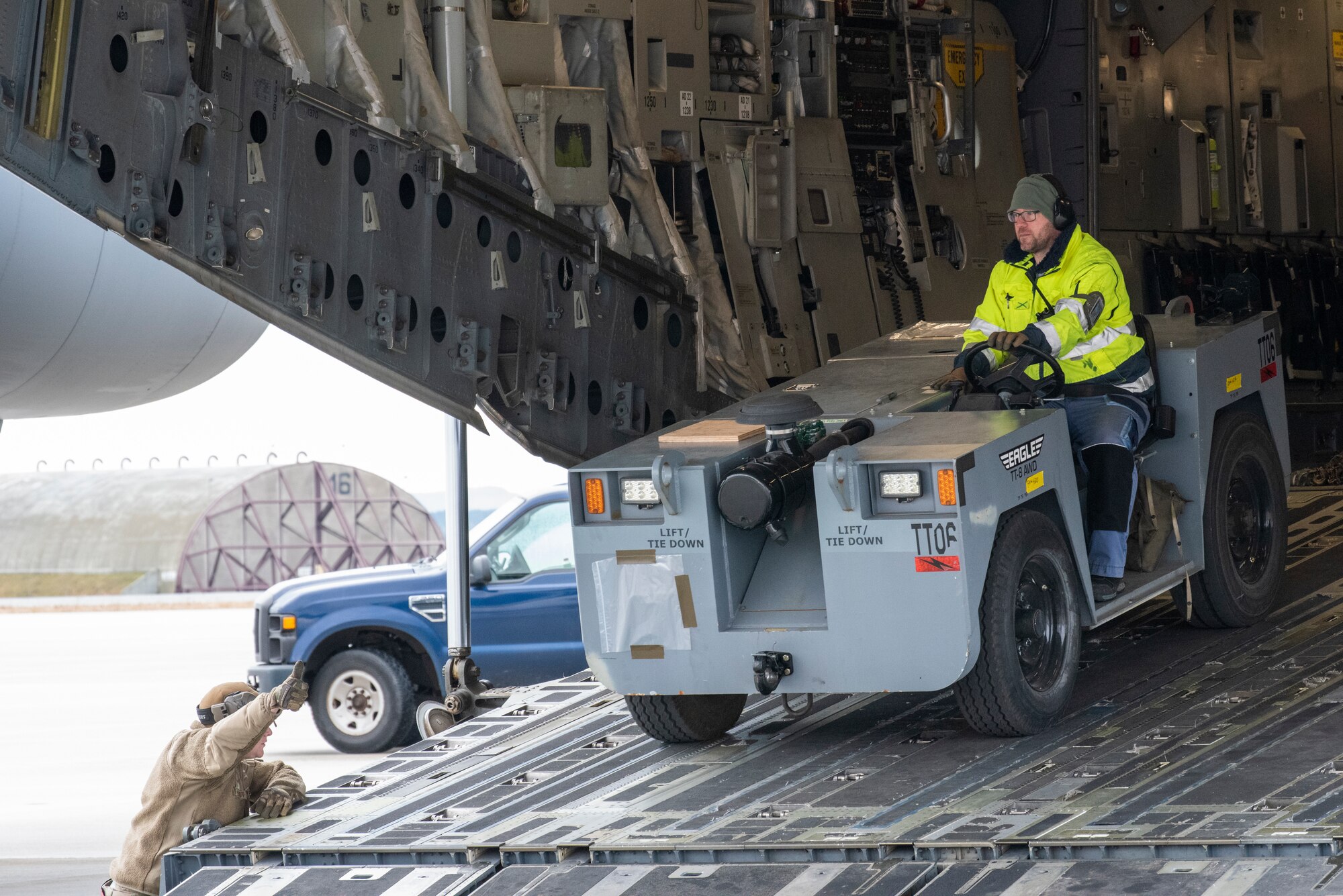 Airmen from the 726th Air Mobility squadron unload cargo from a C-17 Globemaster III aircraft.