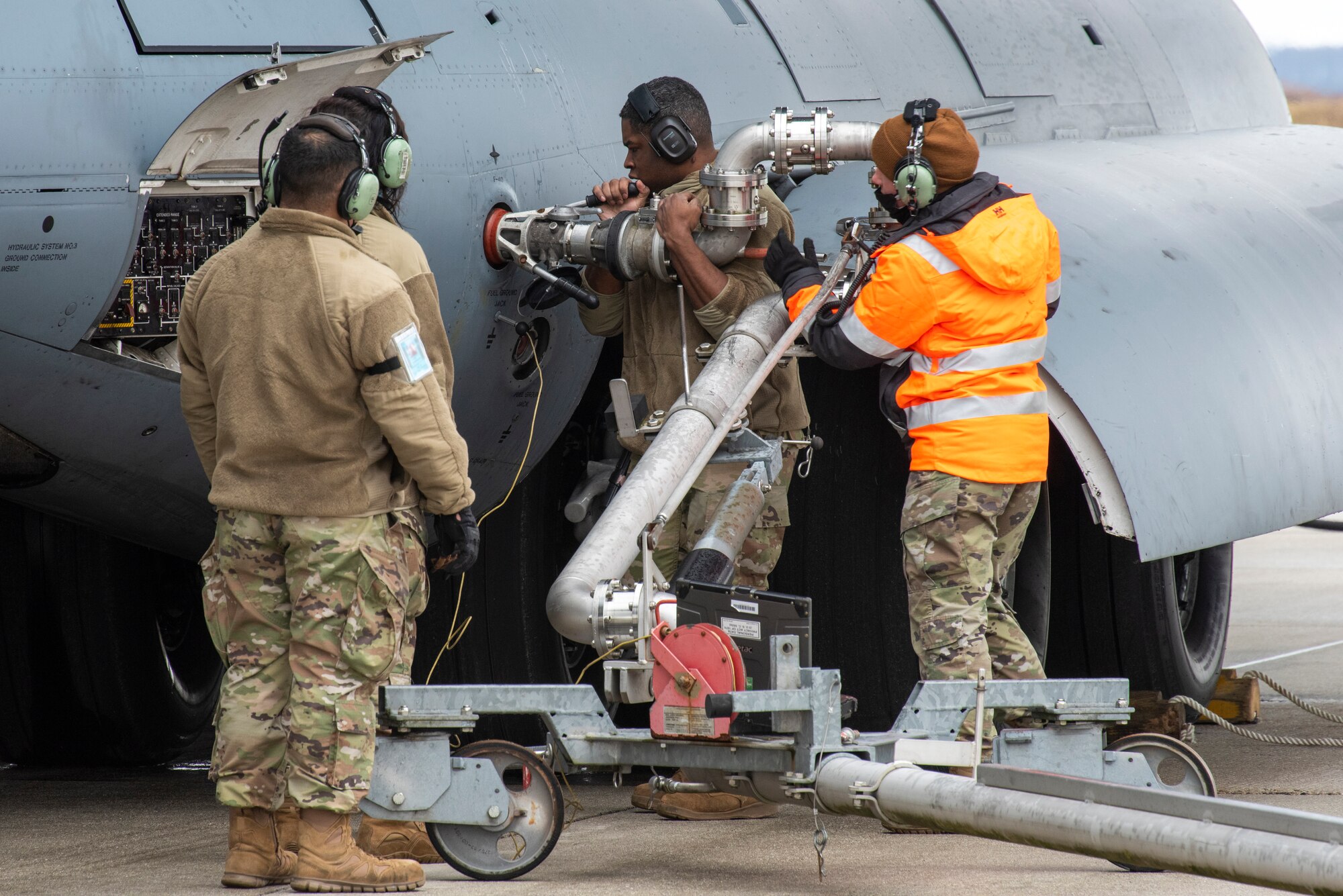 Airmen from the 726th Air Mobility squadron unload cargo from a C-17 Globemaster III aircraft.
