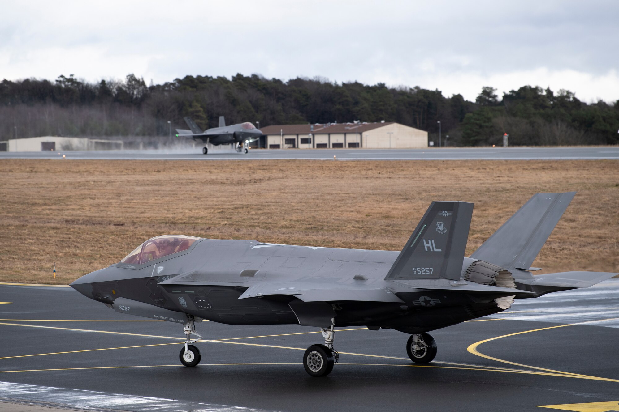 Two U.S. Air Force F-35A Lightning II multirole fighter jets from the 34th Fighter Squadron, 388th Fighter Wing, taxi on the flightline after arriving at Spangdahlem Air Base, Germany, Feb. 16, 2022, to bolster readiness and enhance capabilities with regional partners and allies.