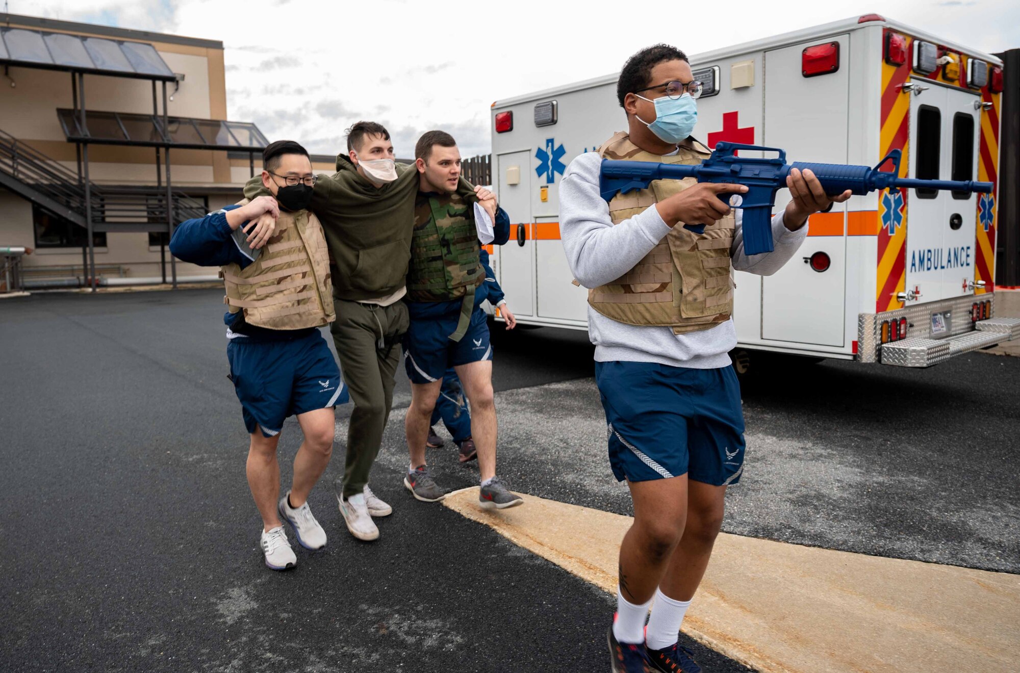 Airmen from the 436th Medical Group escort a patient to a simulated rescue zone during the capstone exercise of a Tactical Combat Casualty Care class at Dover Air Force Base, Delaware, Feb. 18, 2022. Held by the 436th MDG, this is the second TCCC Combat LifeSaver course for medical Airmen who are not frontline responders. During TCCC CLS, Airmen are taught life-saving skills and tested during a rigorous cap-stone exercise. (U.S. Air Force photo by Senior Airman Faith Schaefer)