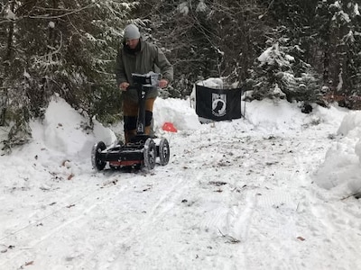 A Defense POW/MIA Accounting Agency investigative team member uses ground penetrating radar in Poland, January 2022. The DPAA teams put up a POW/MIA flag at all sites as a reminder for what they are working. (Courtesy photo)