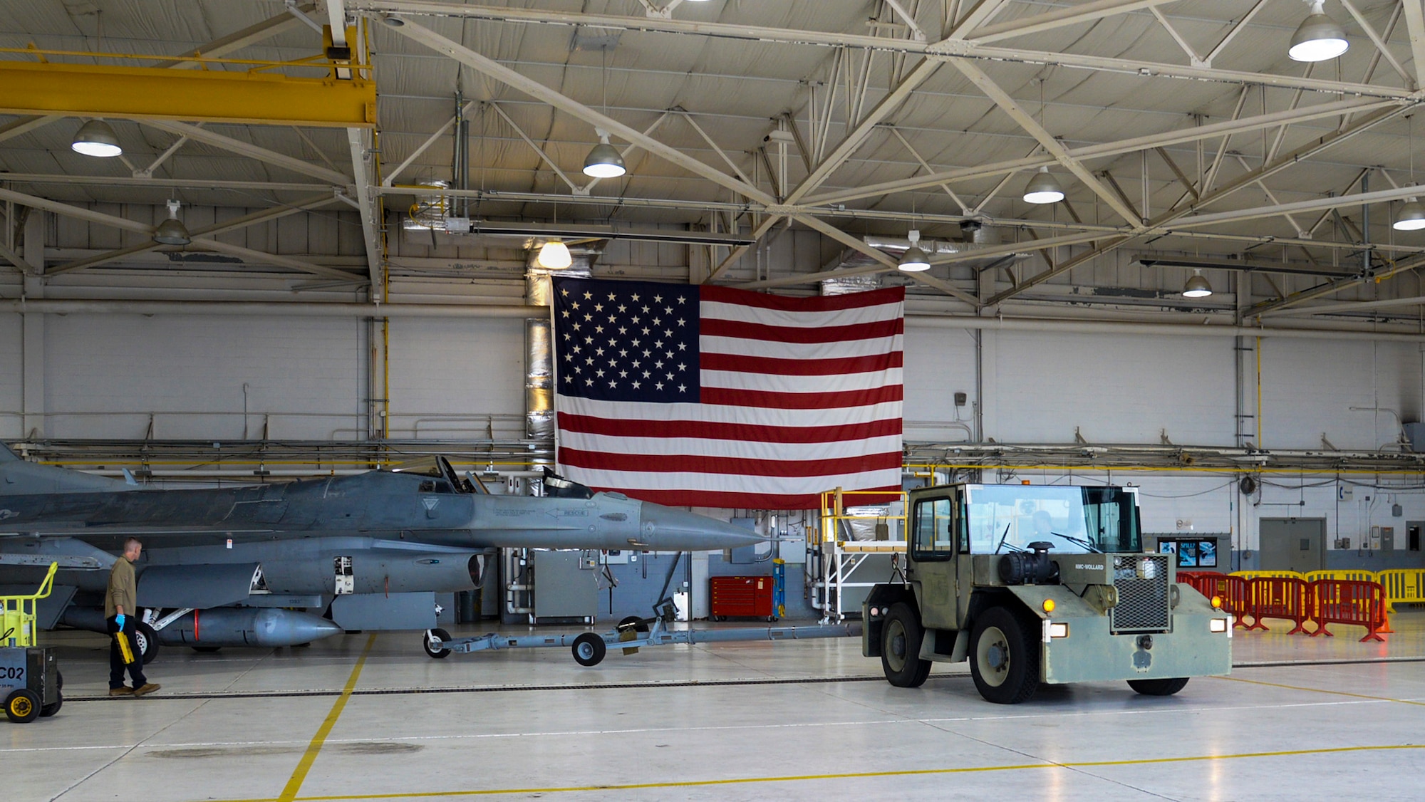 An image of a U.S. Air Force F-16C Fighting Falcon being towed out of the main hangar at the 177th Fighter Wing of the New Jersey Air National Guard, Egg Harbor Township, New Jersey.