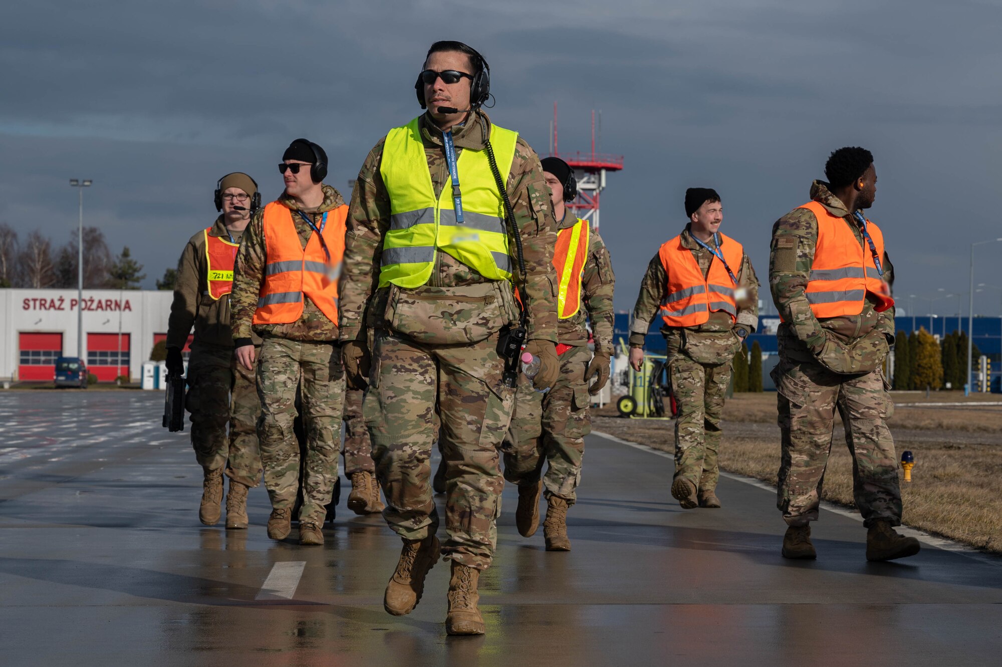 Maintainers and aerial porters walk on the Rzeszow-Jasionka airfield.