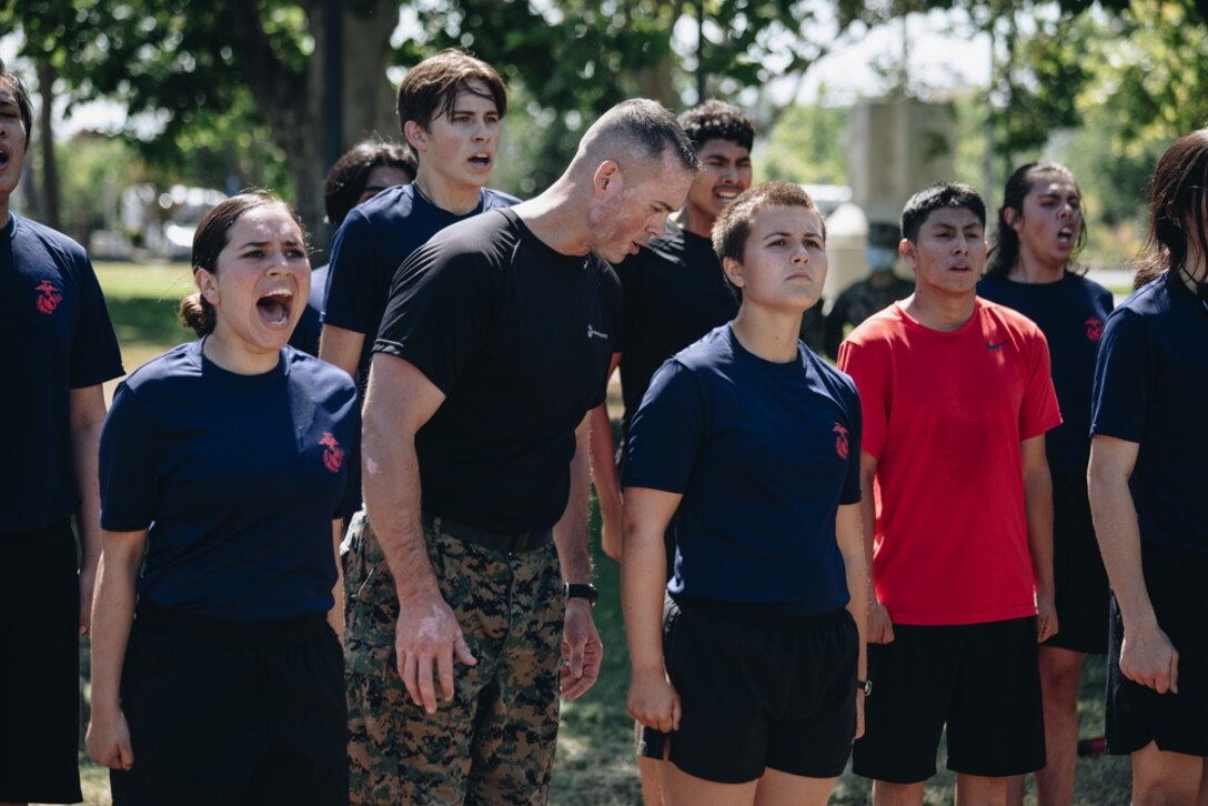 U.S. Marine Corps Gunnery Sgt. Benjamin Lindsey, the station commander for Recruiting Sub-Station Berkeley, corrects a future Marine during Recruiting Station San Francisco's family day event in Union City, California on July 17, 2021. Recruiting Station San Francisco held a family day to familiarize future Marines with the physical and mental challenges they must face in order to become a United States Marine. (U.S. Marine Corps photo by Sgt. Alina Thackray)