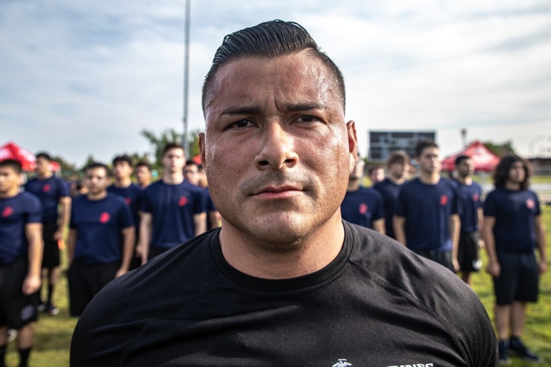 U.S. Marine Corps Gunnery Sgt. Anthony Rubio, a Staff Non-Commissioned Officer in Charge with Recruiting Sub-Station Upland, Recruiting Station Riverside, 12th Marine Corps District, stands at attention during an annual pool function at Moreno Valley, California, July 24, 2021. The annual pool function is an opportunity for future Marines to build camaraderie, strengthen their commitment to the Marine Corps and prepare for recruit training by competing in athletic competitions and receiving military related periods of instruction. (U.S. Marine Corps photo by Cpl. Ana S. Madrigal)