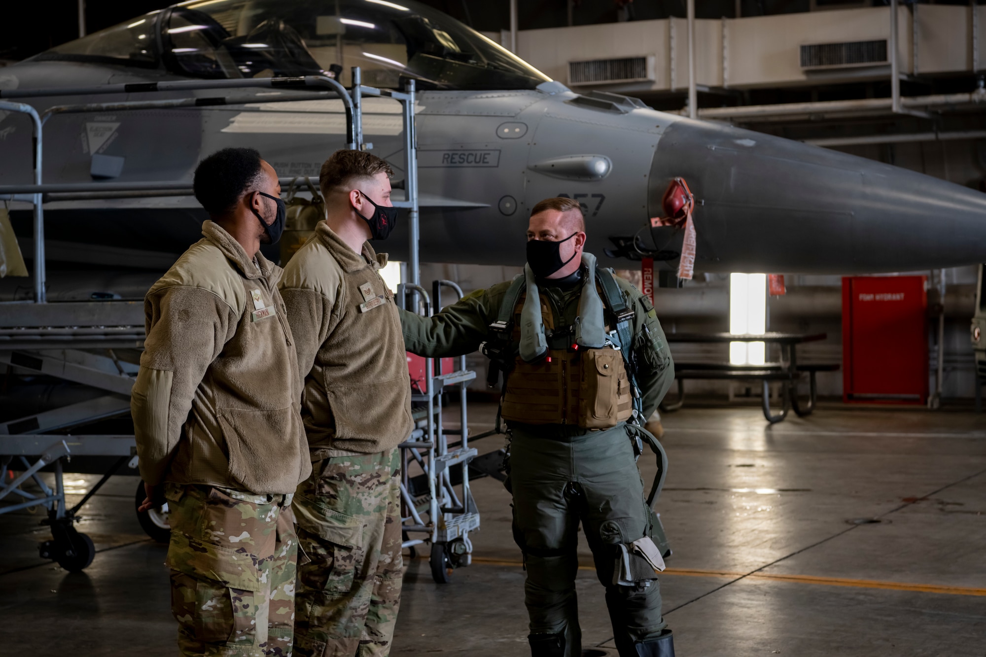 Commander congratulating Airmen.