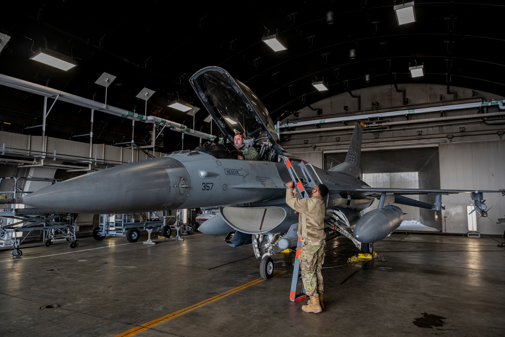 Airman removing ladder from the side of the F-16 Fighting Falcon at Misawa Air Base.