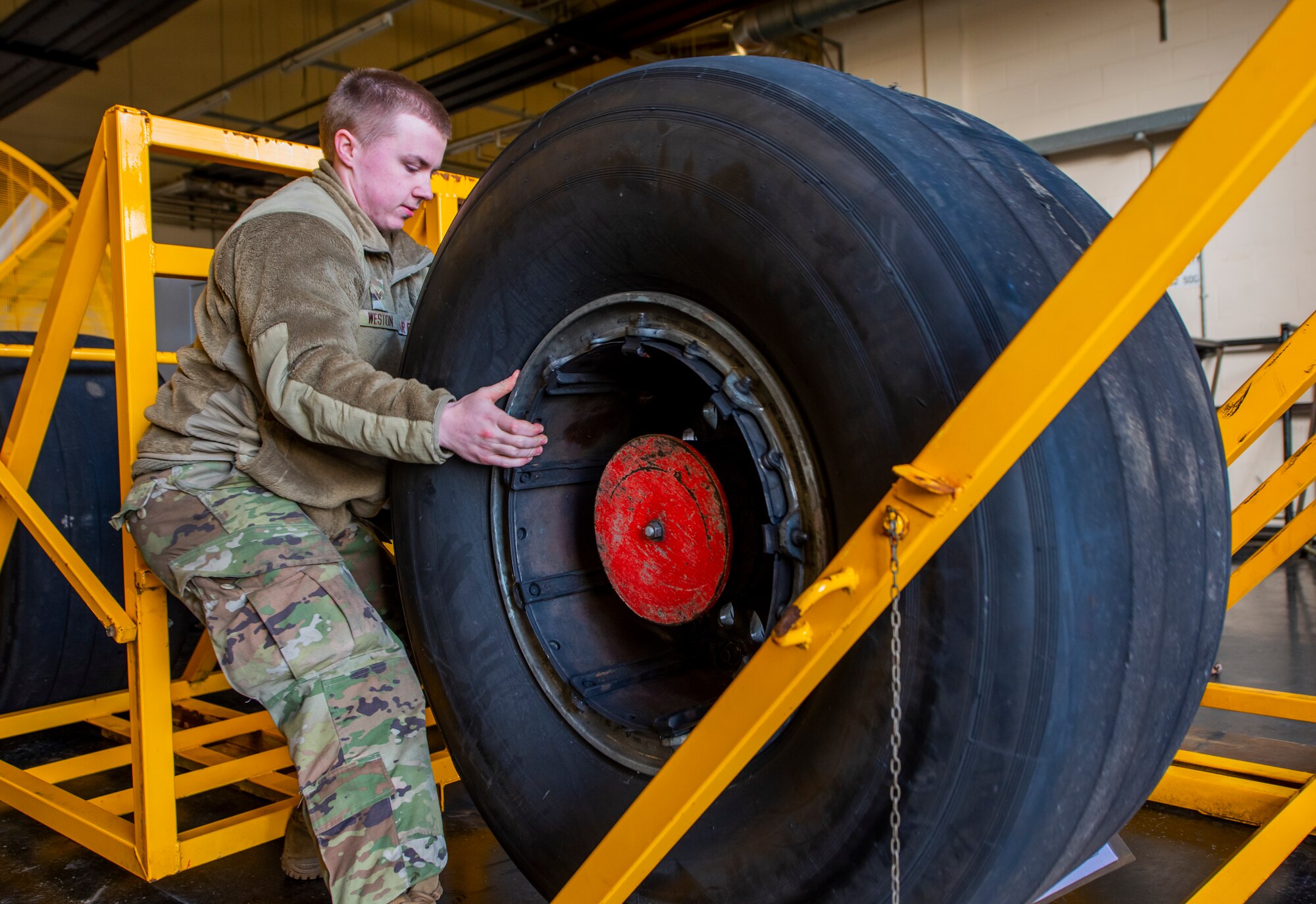 A 100th Aircraft Maintenance Squadron Airman unloads a C-17 Globemaster III aircraft wheel that was delivered from Royal Air Force Brize Norton at RAF Mildenhall, England, Feb. 24, 2022. Once the 100th AMXS wheel and tire team runs the wheels through their equipment, they will be returned to RAF Brize Norton’s team who will install the new tires and get them back in the air. (U.S. Air Force photo by Senior Airman Kevin Long)