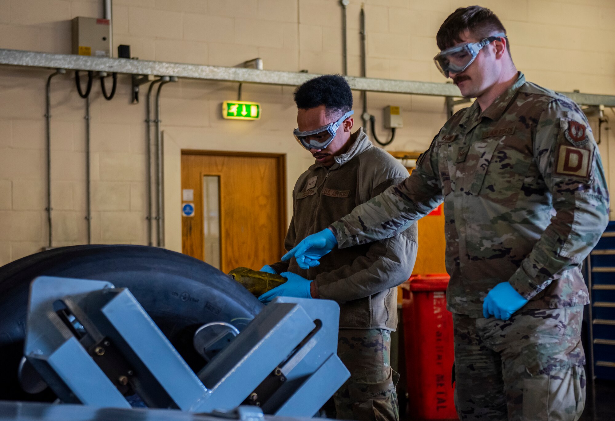 Airmen from the 100th Aircraft Maintenance Squadron use the bead breaker machine to separate a C-17 Globemaster III aircraft wheel and tire from Royal Air Force Brize Norton at RAF Mildenhall, England, Feb. 24, 2022. This is just one example of the ways that the U.S. Air Force and RAF support each other to keep the mission going. (U.S. Air Force photo by Senior Airman Kevin Long)