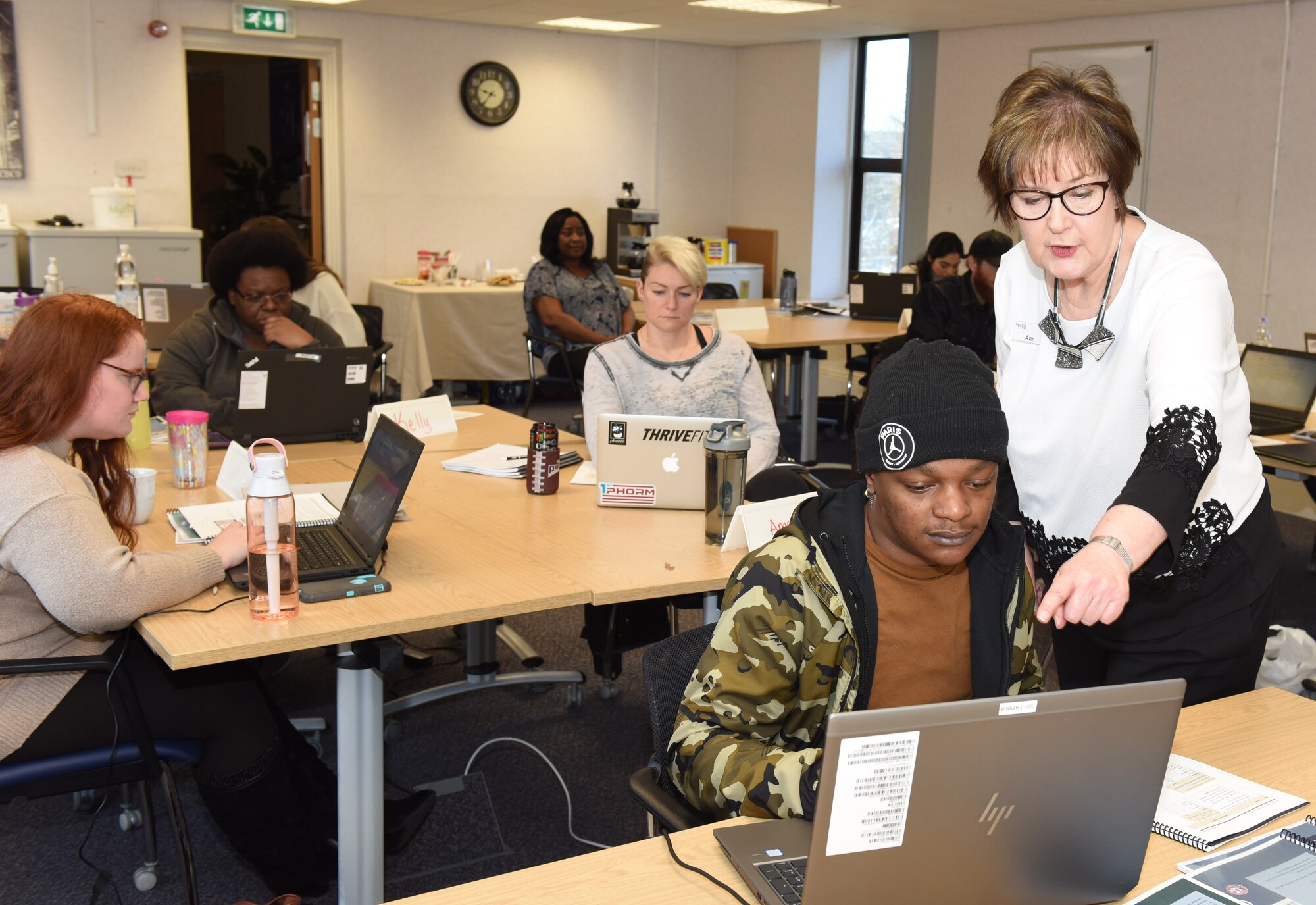 Ann Norris, right, standing, Department of Labor facilitator, explains information about a website to Dexter Howard, 100th Logistics Readiness Squadron spouse, at the Transition Employment Assistance for Military Spouses workshop on RAF Mildenhall, England, Feb. 23, 2022. The workshop was the first in U.S. Air Forces in Europe – Air Forces Africa to be held in-person rather than virtually, at the Airman and Family Readiness Center. (U.S. Air Force photo by Karen Abeyasekere)