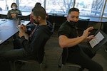 Chicago MEPS personnel Nelson Gonzalez (left) and U.S. Army Sgt. Arnaldo Garcia (right) participate in a communication building exercise during CARES Day activities.