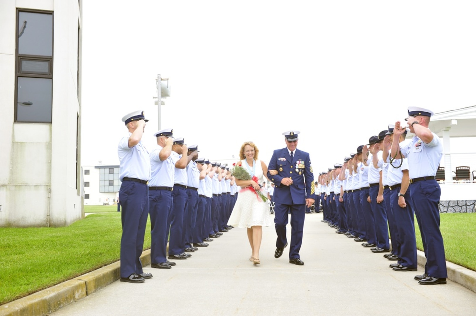 Master Chief Petty Officer Michael P. Leavitt (ret.) and his wife, Debra, depart a change-of-watch ceremony Thursday, May 22, 2014 at Coast Guard Training Center Cape May, N.J. After the change-of watch ceremony, in which Leavitt transferred his duties as MCPOCG to Master Chief Petty Officer Steven W. Cantrell, Leavitt retired following 32 years of Coast Guard service. U.S Coast Guard photo by Petty Officer 3rd Class Cynthia Oldham