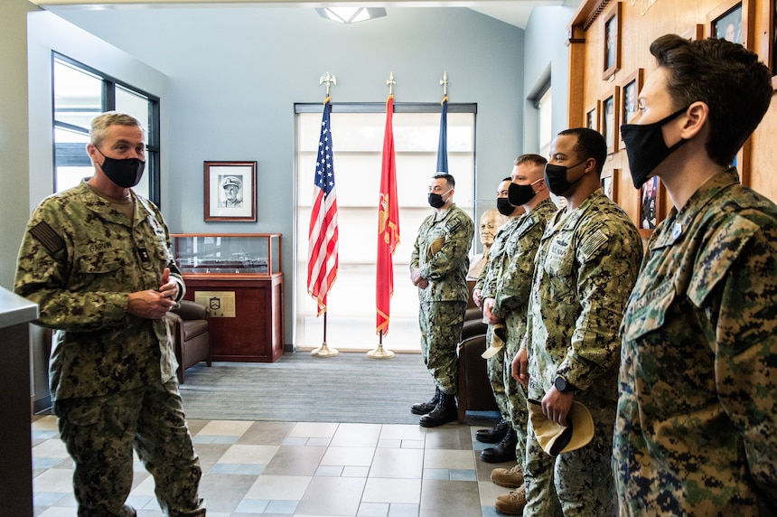 Rear Adm. Pete Garvin, commander, Naval Education and Training Command (NETC), left, recognizes Officer Training Command Newport (OTCN) staff members for their support
