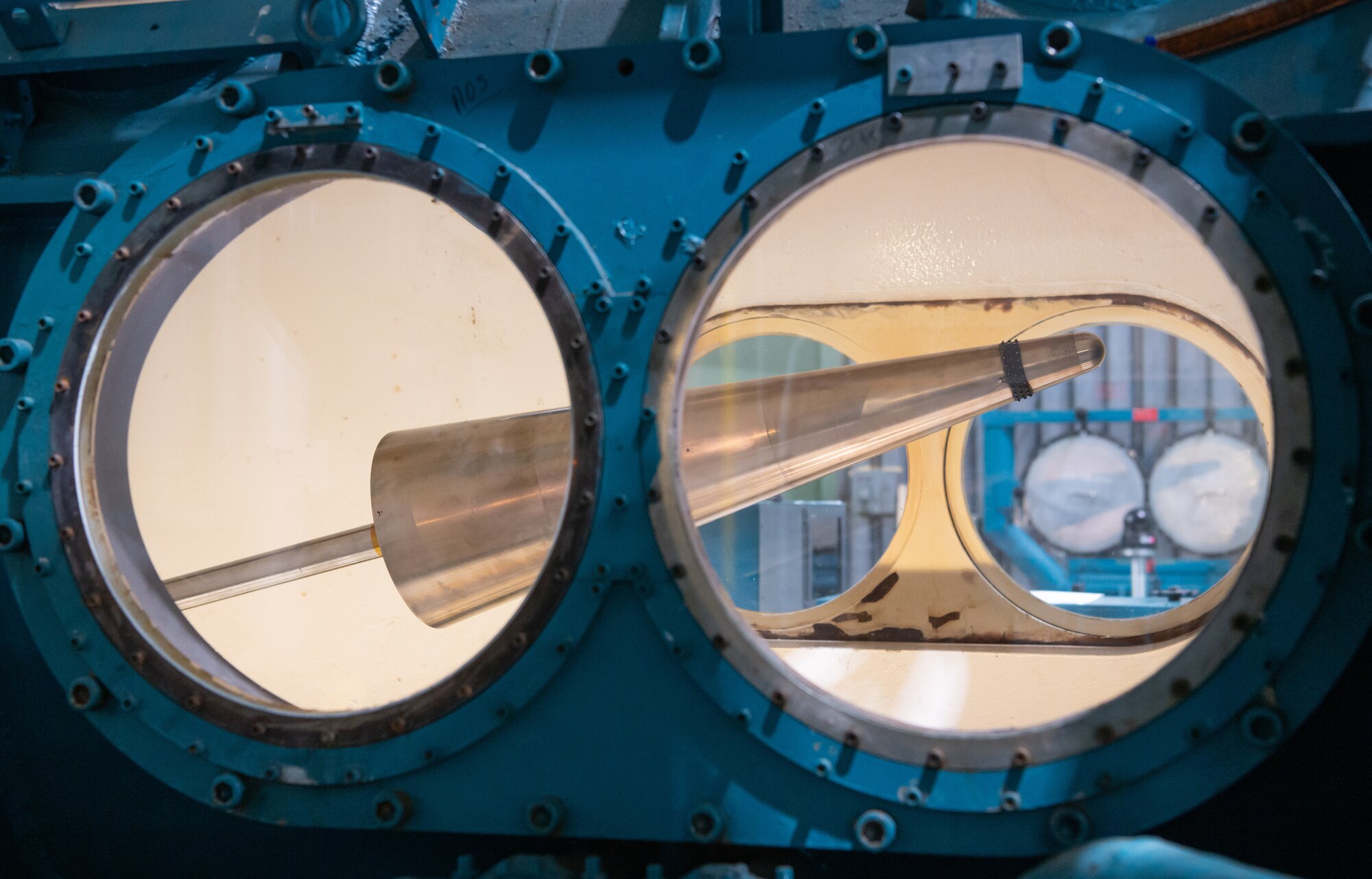 A standard test model cone is seen through portholes in Tunnel C of the von Kármán Gas Dynamics Facility at Arnold Air Force Base, Tenn.