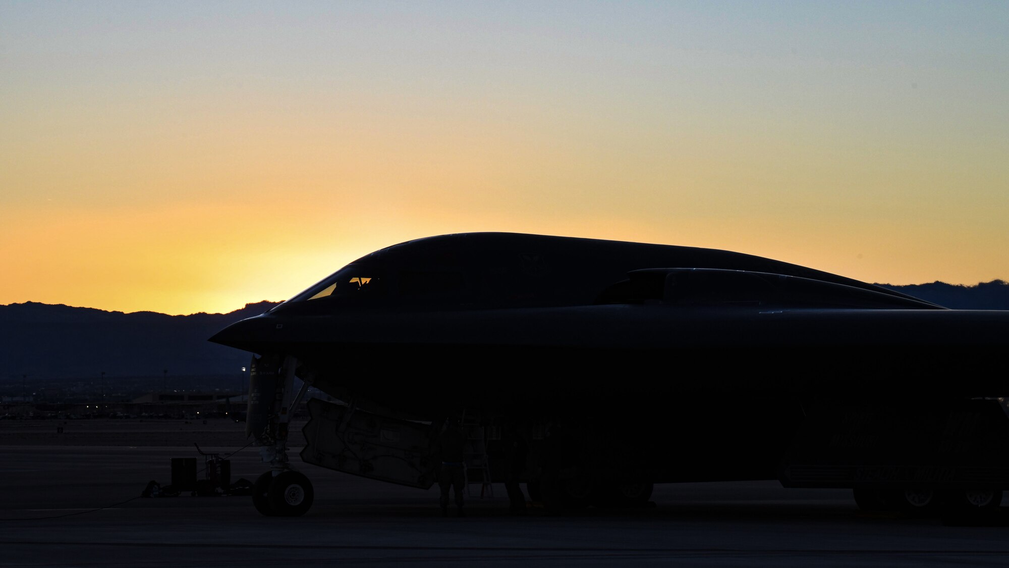 A B-2 Spirit sits on the Nellis Air Force Base flightline at sunset.