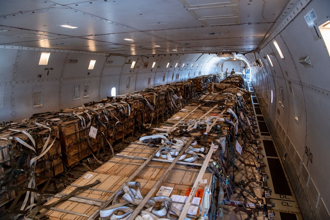 A large amount of supplies is seen inside an aircraft.