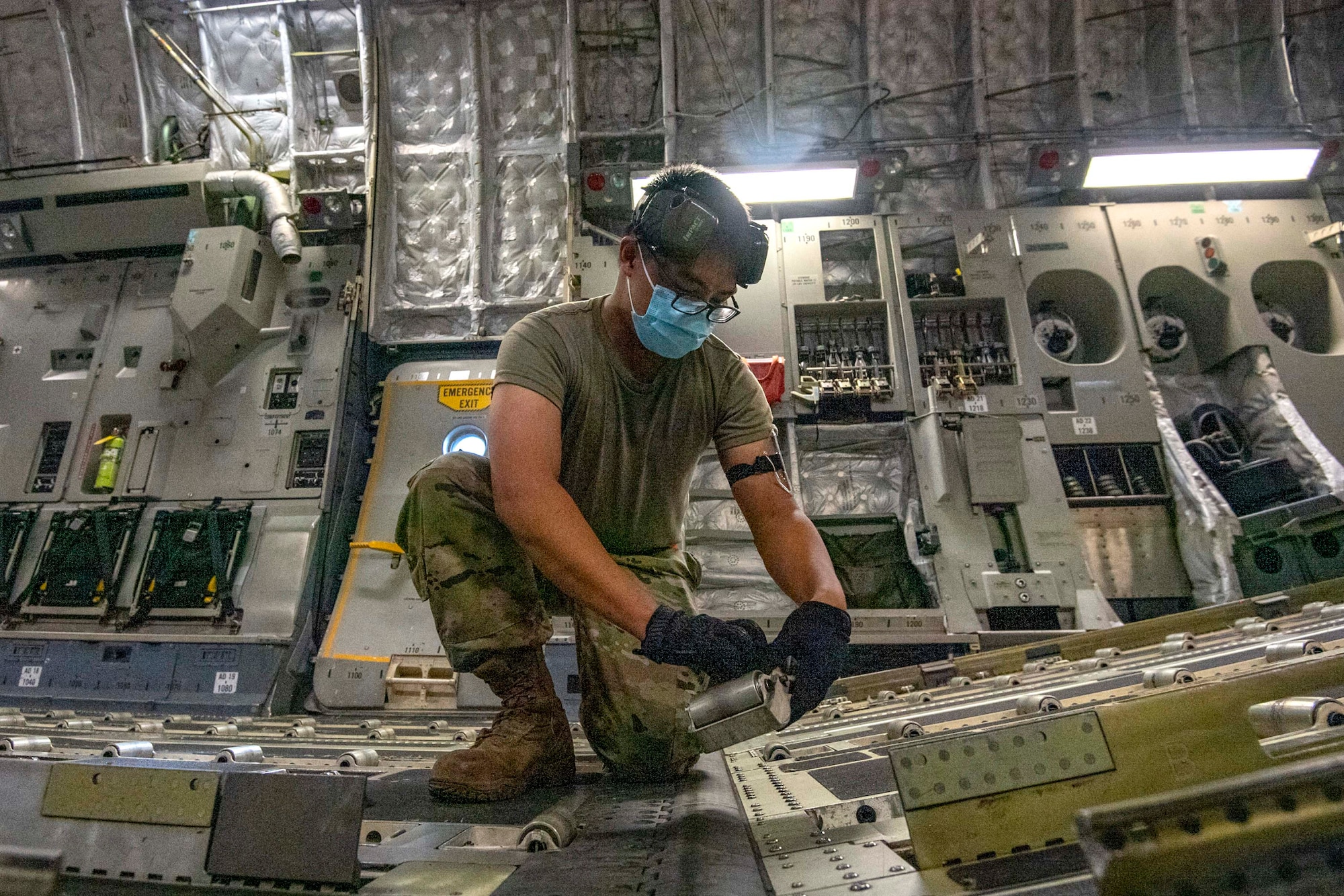 Senior Airman Alvarado Denton, 48th Aerial Port Squadron (APS), cargo specialist, reconfigures a Hawaii Air National Guard C-17 from the 154th Wing to receive cargo, while at Joint Base Pearl Harbor-Hickam, Jan. 20, 2022.