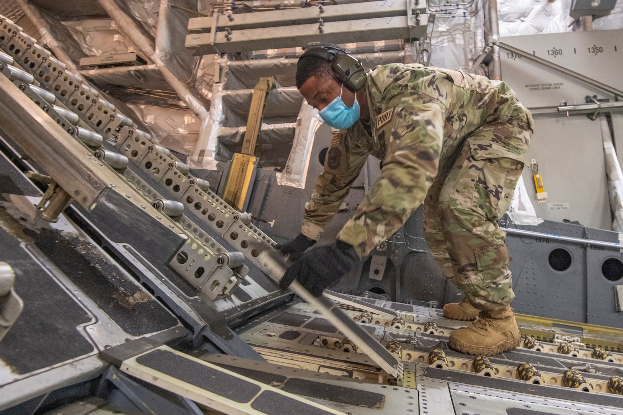 Staff Sgt. Rontrell Russell, 48th Aerial Port Squadron (APS), cargo specialist, reconfigures a Hawaii Air National Guard C-17 from the 154th Wing to receive cargo while at Joint Base Pearl Harbor-Hickam, Jan. 20, 2022.