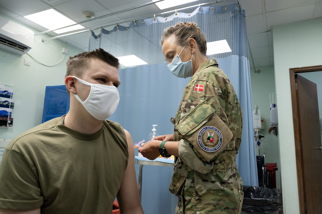 An airman gets vaccinated.