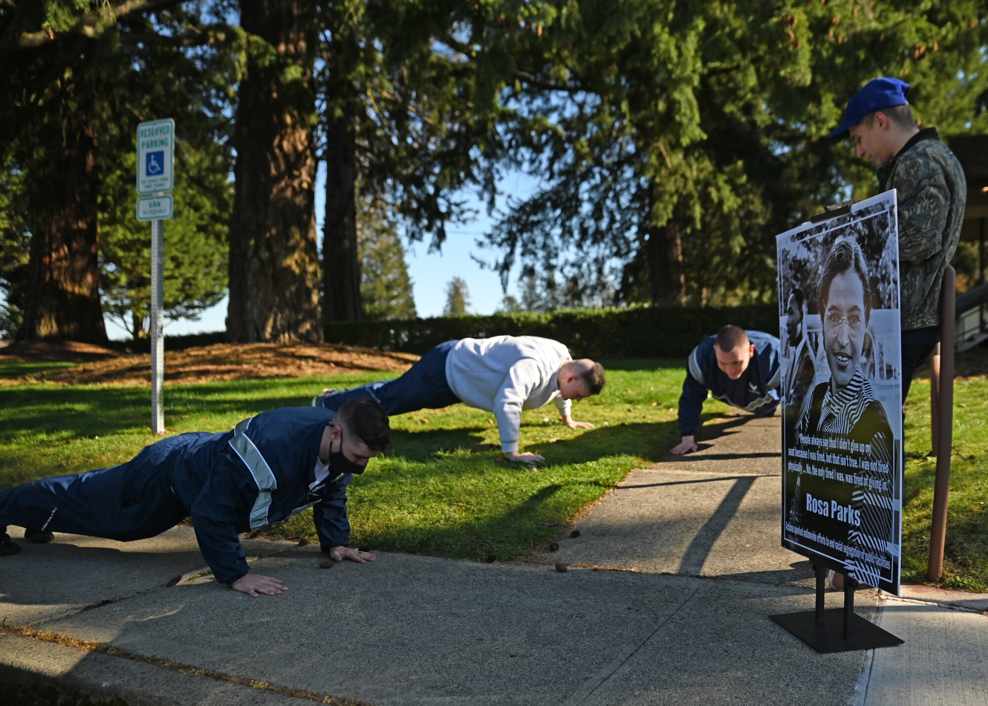 U.S. Airmen with the McChord Field Honor Guard do push ups during the Black History Month Amazing Race event at Joint Base Lewis-McChord, Washington, Feb. 23, 2022. The Amazing Race is one of Team McChord’s Black History Month timed events, where teams must answer historic questions correctly before they receive the clue to their next stop along the run. (U.S. Air Force photo by Airman 1st Class Callie Norton)