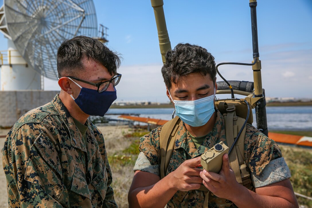 U.S. Marines assigned to I Marine Expeditionary Force Information Group, are taught how to jam frequencies using the MODI II electronic warfare system during a communications field testing exercise at Naval Air Station Point Mugu, California, Apr. 22, 2021. The purpose of the exercise was to evaluate the capability and compatibility of commercial equipment with tactical assets in austere environments. (U.S. Marine Corps photo by Cpl. Thomas Spencer)