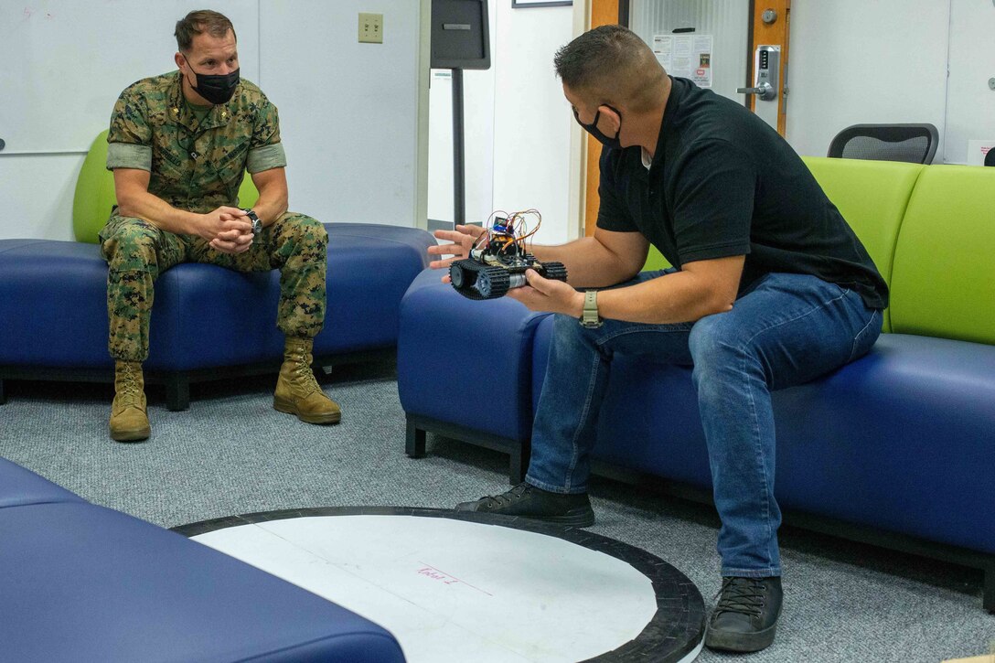 U.S. Marine Corps Maj. Steven Murello (left), the Information Warfare Coordinator with I Marine Expeditionary Force Information Group, discusses autonomous robotic coding with MSgt. Frank Hernandez, data systems chief with 9th Communication Battalion, I MIG, during the Building Momentum Innovation Bootcamp at Camp Pendleton, California, Sept. 30, 2021. This event provided I MIG Marines the opportunity to test critical thinking with new technology and enhance unit capabilities with these new skills. (U.S. Marine Corps photo by Cpl. Aidan Hekker)