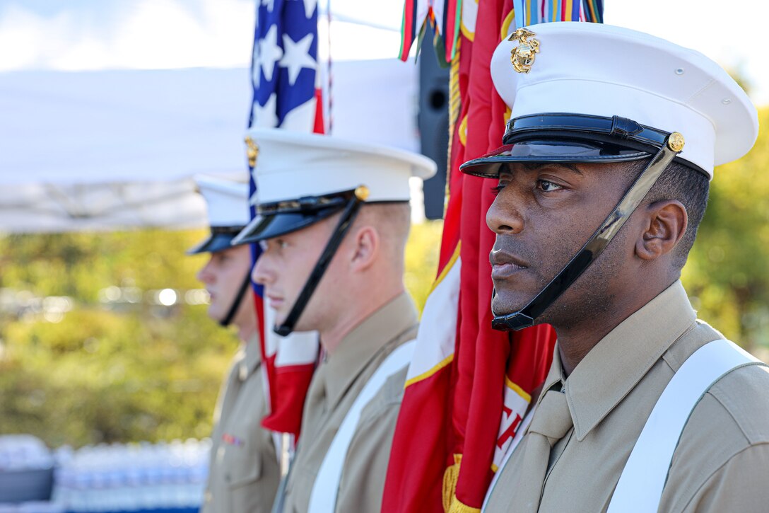 U.S. Marine color guard with 9th Communication Battalion, I Marine Expeditionary Force Information Group (I MIG), present colors at the Santee Veterans Memorial Dedication at Santee, California, Nov. 11, 2021. The Santee community dedicated a monument to honor American veterans in support of those who served past and present in the United States armed forces. I MIG Marines interacted with the community as an effort to strengthen relations with the Corps. (U.S. Marine Corps photo by Cpl. Aidan Hekker)