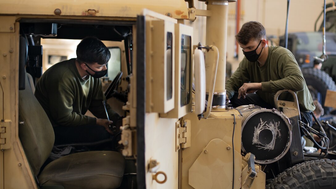 U.S. Marine Corps Lance Cpl. Hunter Garrison (right) and Lance Cpl. Joshua Hasty, both automotive maintenance technicians with Combat Service Support Company, I Marine Expeditionary Force Support Battalion, I MEF Information Group, repair a Humvee motor at Marine Corps Base Camp Pendleton, California, Jan. 27, 2022. The motor transport platoon at CSSC provides I MIG the logistical requirement for transport and tactical vehicles ensuring consistent mission readiness and success. (U.S. Marine Corps photo by Cpl. Ian M. Simmons)