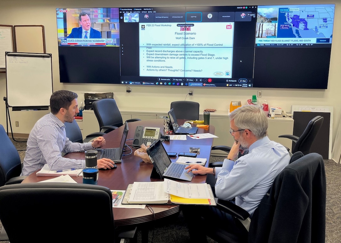 Anthony Rodino, Water Management Section chief, gives a virtual briefing from the Nashville District Water Management Center, on Water Management’s role in flood preparation for the upcoming flood season while Ben Rohrbach, Engineering and Construction Division chief, reviews data on his laptop.