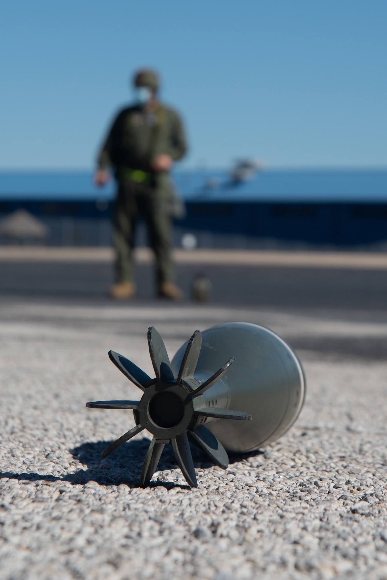 Airman guards an artificial UXO during a Post-Attack Reconnaissance sweep.