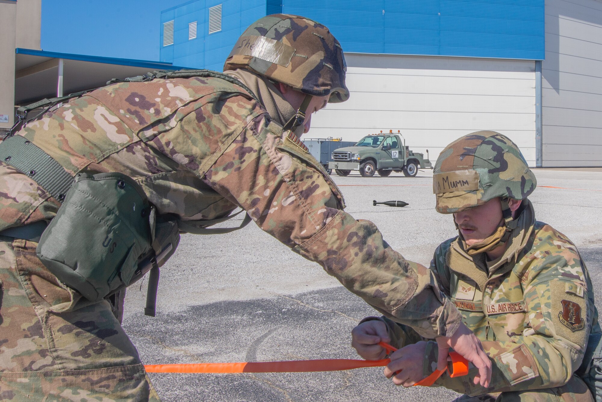 Airmen tie off a cordon around an artificial UXO.