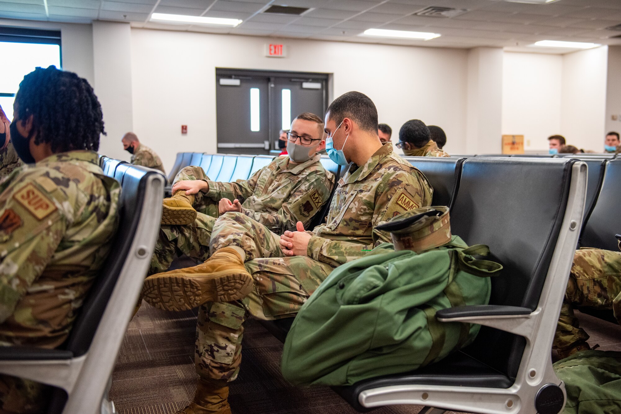 Photo of Airmen sitting in chairs
