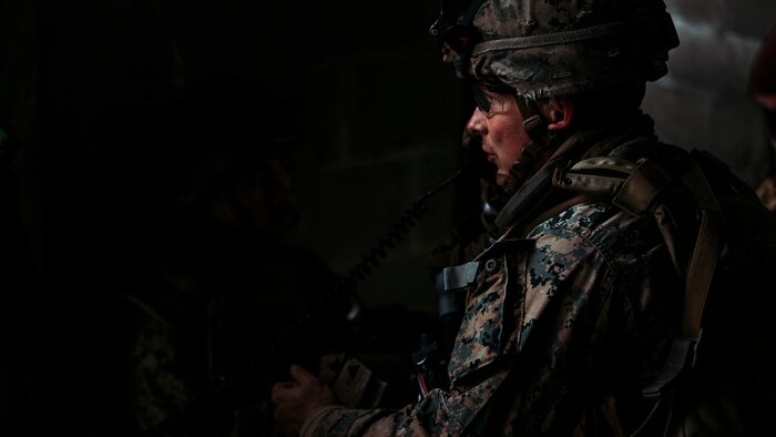 Marine standing in darkened area