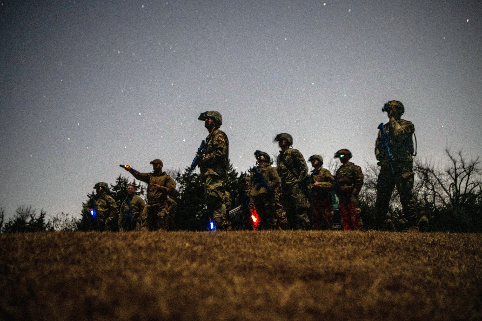 Mission Sustainment Team students use night vision goggles during a field training exercise i