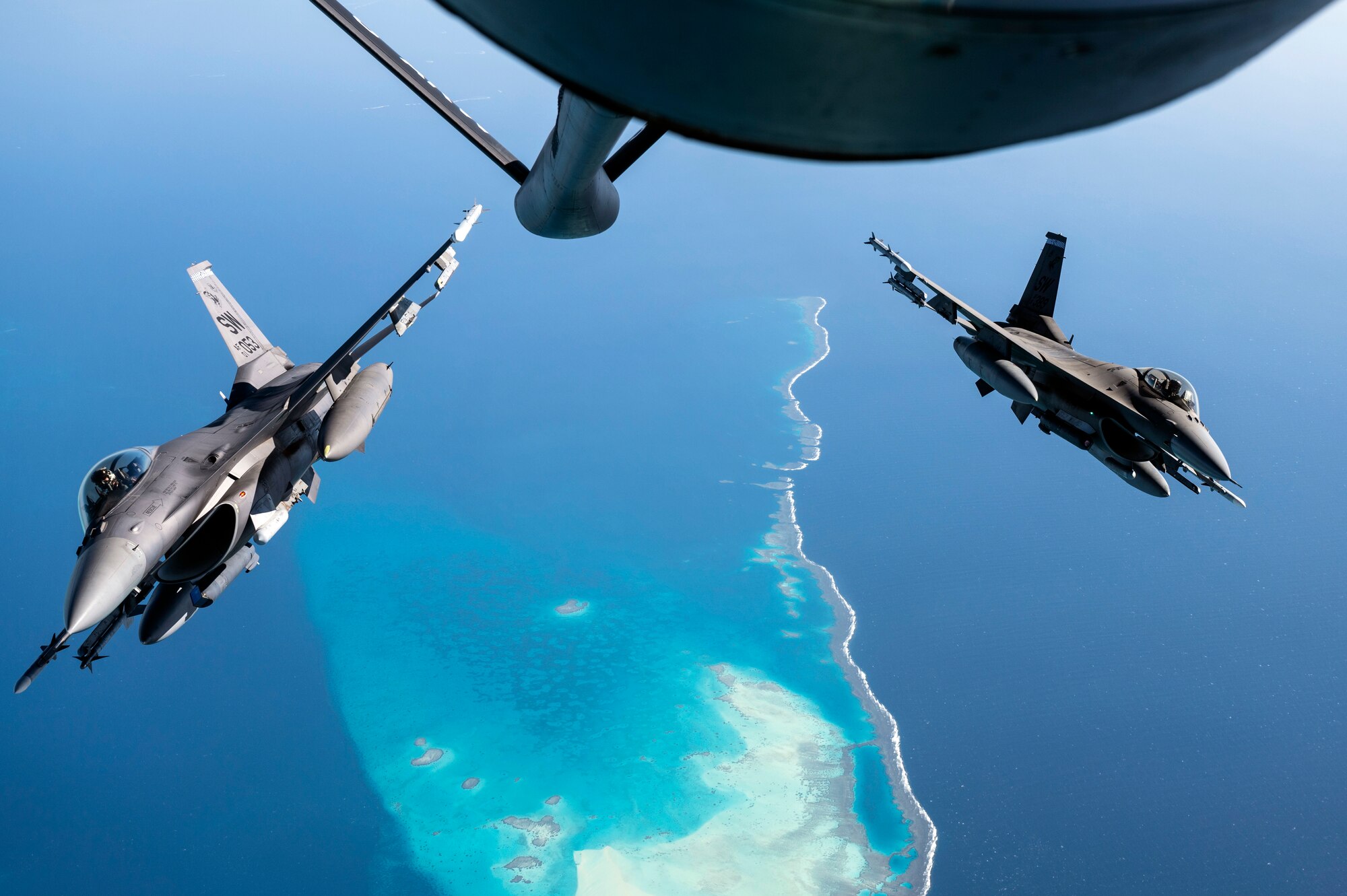 U.S. Air Force F-16 Fighting Falcons assigned to the 332nd Air Expeditionary Wing break away from behind a U.S. Air Force KC-135 Stratotanker