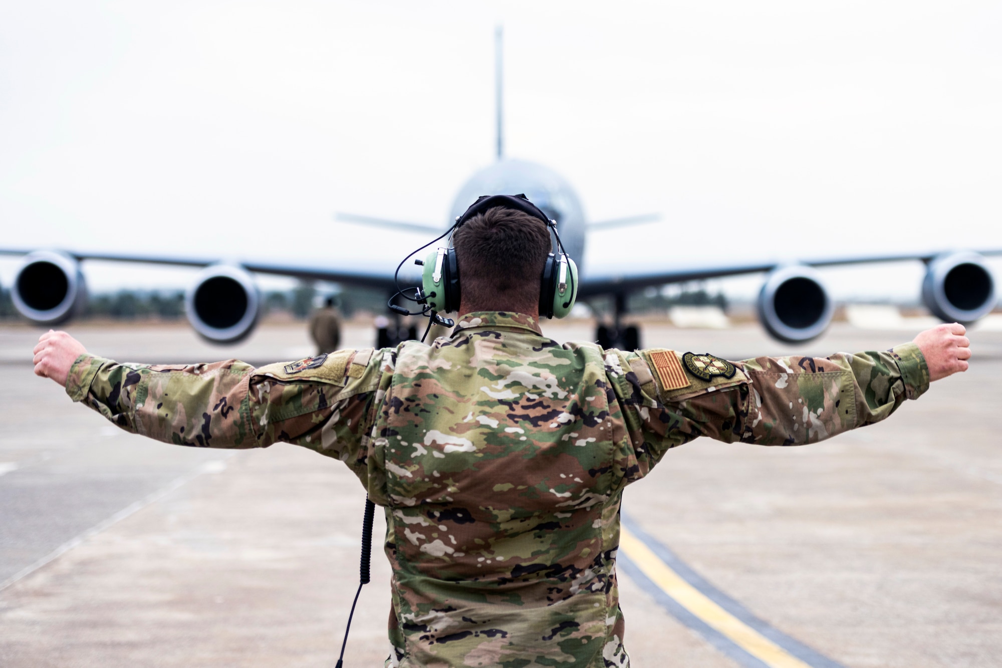 Staff Sgt. Zane House, an F-16 Fighting Falcon dedicated crew chief assigned to the 55th Expeditionary Fighter Generation Squadron, marshals a KC-135 Stratotanker