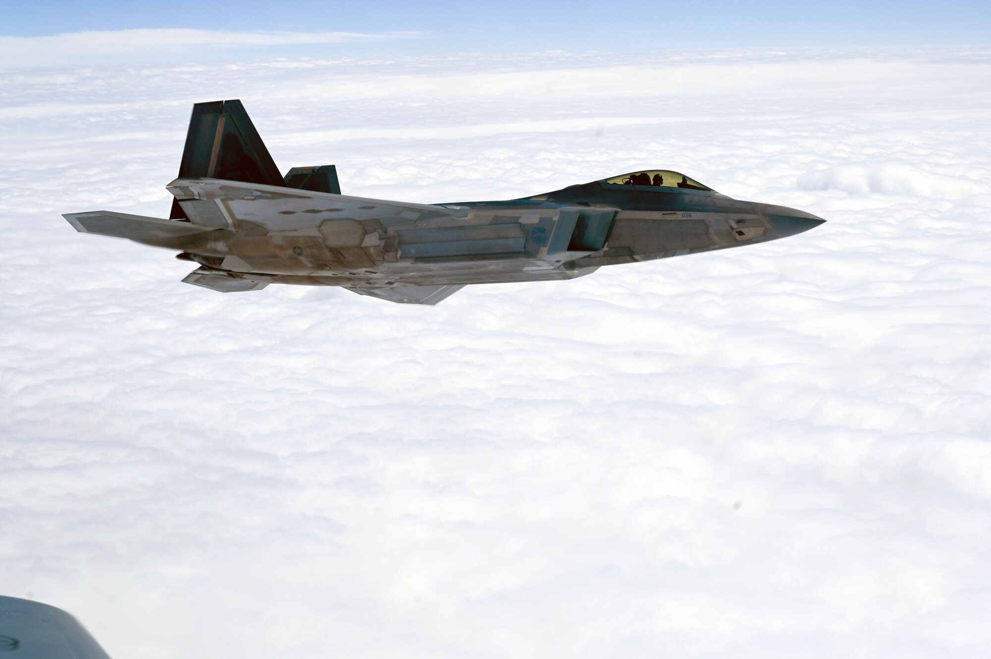 F-22 Raptor with the 325th Fighter Wing at Tyndall Air Force Base, Fla., receive fuel from a KC-135 Stratotanker
